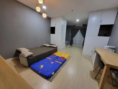 a room with a bed and a table in it at NICE and COZY studio apartment with gym and pool. in Kampar