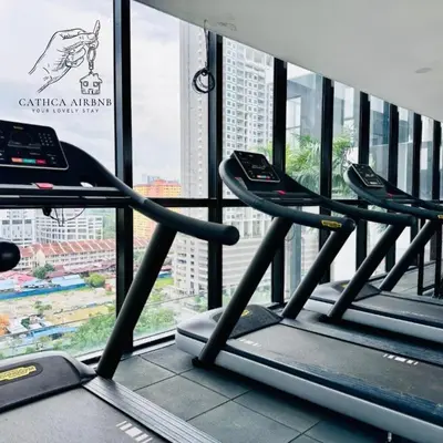 a row of treadmills in a gym with a window at Urban Suites 2BR #SelfCheck-in #6Pax #TopFacilities in Jelutong