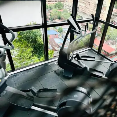 two exercise bikes in a gym with windows at Urban Suites 2BR #SelfCheck-in #6Pax #TopFacilities in Jelutong