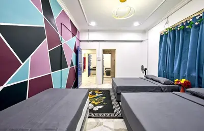 a bedroom with two beds and a colorful wall at Penang Dream Banglo Sleeps 40 in Tanjung Bungah