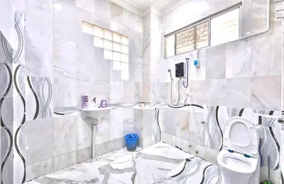 a bathroom with a toilet and a sink at Penang Dream Banglo Sleeps 40 in Tanjung Bungah