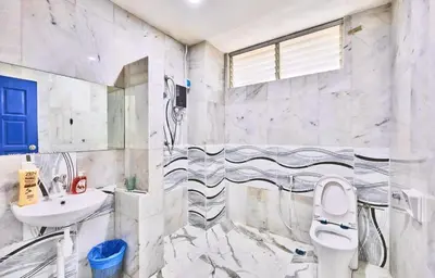 a bathroom with a toilet and a sink at Penang Dream Banglo Events up to 120 Pax in Tanjung Bungah
