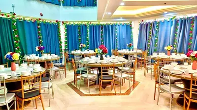 a dining room with tables and chairs and blue curtains at Penang Dream Banglo Events up to 120 Pax in Tanjung Bungah