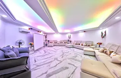 a large room with couches and a white marble floor at Penang Dream Banglo Sleeps 22 in Tanjung Bungah