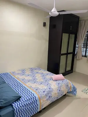 a bedroom with a bed and a ceiling fan at SunShine HomeStay in Bukit Mertajam