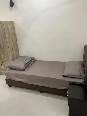 a small bed in a room with at SunShine HomeStay in Bukit Mertajam