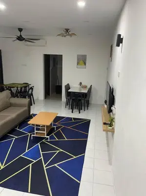 a living room with a blue and yellow carpet at SunShine HomeStay in Bukit Mertajam