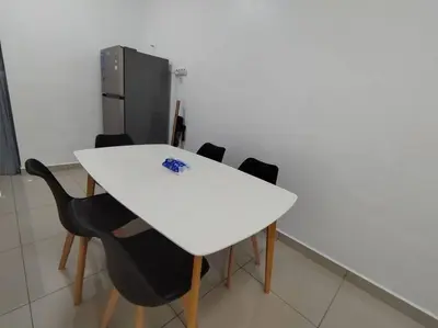 a white table with black chairs and a refrigerator at Nana's Sitiawan Home Stay, Victoria cottage in Sitiawan