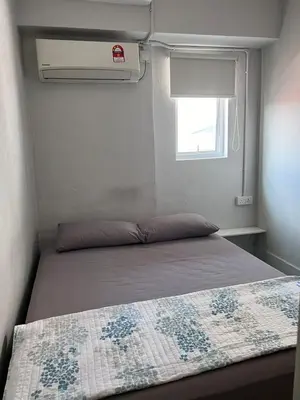 a bed in a small room with a window at Sunshine House in George Town