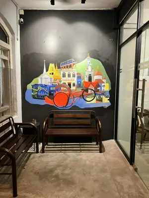a mural on the wall of a room with a bench at Sunshine House in George Town