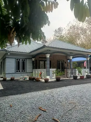 a house with a gambrel roof at Cp homestay in Batu Kurau