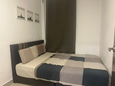 a bedroom with a bed with a checkered blanket at Ipoh Town Majestic 3R2B 10paxs Remi Suite in Ipoh