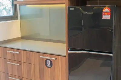 a kitchen with a microwave and a wooden cabinet at Ipoh Tambun Sunway Onsen Suite 3R2B Maya in Tambun