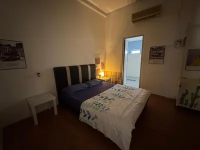 a bedroom with a bed and a table and a window at Wi-Fi 100MB free Ipoh Town Holiday House Tmn Shatin S36 in Ipoh