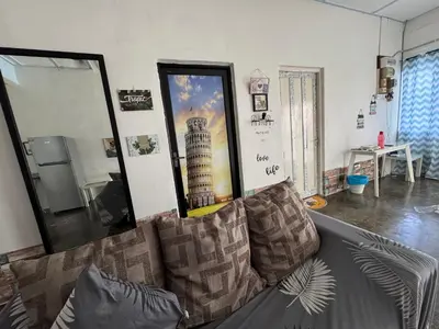 a living room with a couch and a large mirror at Wi-Fi 100MB free Ipoh Town Holiday House Tmn Shatin S36 in Ipoh