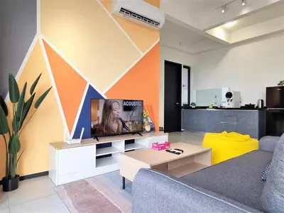 a living room with a couch and a tv at Cozy Minimalist Suite at Urban Suites Georgetown by SuperStay in Jelutong