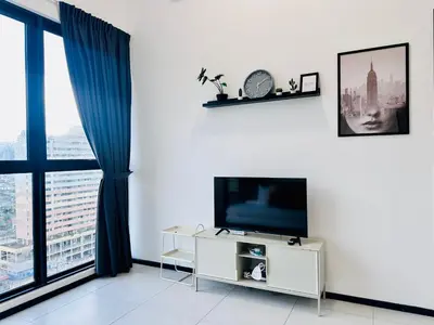 a living room with a tv and a large window at New Comfy Urban Suite Homestay at Georgetown for family by Urban Staycations LOD COSY in Jelutong