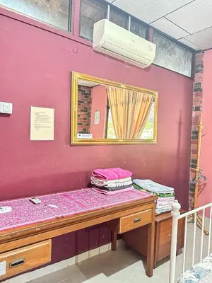 a room with a counter with a mirror and a table at Dusun Indah Cottage 2 in Bayan Lepas