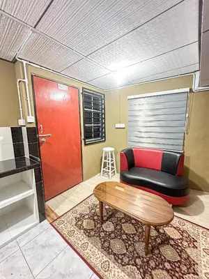 a living room with a couch and a coffee table at Dusun Indah Cottage 3 in Bayan Lepas