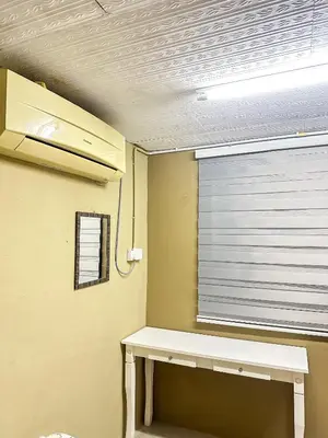 a room with a window and a white table at Dusun Indah Cottage 3 in Bayan Lepas