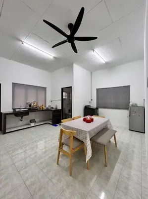 a kitchen with a table and a ceiling fan at Juzt Homestay Kpg Boyan in Taiping