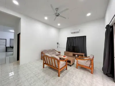 a living room with two chairs and a television at Juzt Homestay Kpg Boyan in Taiping