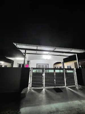 a gate in front of a building at night at Juzt Homestay Kpg Boyan in Taiping