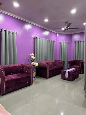 a purple living room with couches and curtains at ARY&ZZ Homestay for islam guests in Tanjung Karang