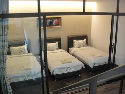 a room with two bunk beds and a mirror at Batu Ferringhi - Shamrock Beach Villas, Penang in Batu Ferringhi