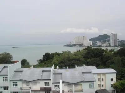 a row of houses with a city in the background at Batu Ferringhi - Shamrock Beach Villas, Penang in Batu Ferringhi