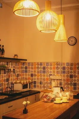 a kitchen with three lights and a counter top at FA House by the Beach in Tanjung Bungah
