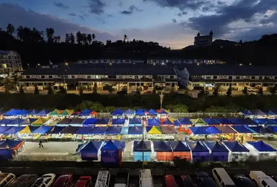 a group of tents in a parking lot at night at G Residence - 2BR Family Suite Barrington Night Market - 3 in Brinchang
