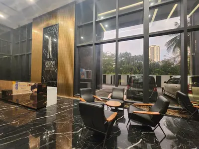 a lobby with chairs and tables in a building at Executive Premium Urban Suites - Jelutong in Jelutong