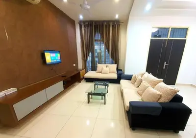 a living room with a couch and a tv at CozyHouse 4ROOM 4BATH ROOM 8PAX@Near BM Icon city in Bukit Mertajam