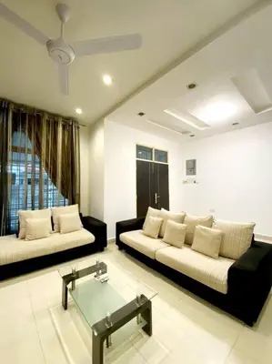 a living room with two couches and a glass table at CozyHouse 4ROOM 4BATH ROOM 8PAX@Near BM Icon city in Bukit Mertajam