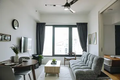 a living room with a couch and a table at The ELM, 2BR Cityview by W. Stay @ Tropicana 218 Macalister in George Town
