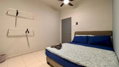 a bedroom with a bed with a teddy bear on it at Spacious HOUSE 4R 8pax WiFi-S Pic-Airport in Bayan Lepas