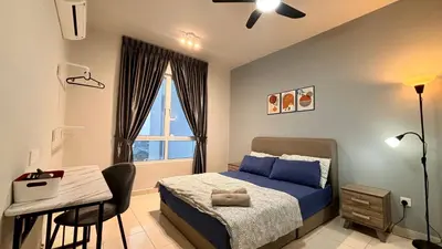 a bedroom with a bed and a desk and a window at Spacious HOUSE 4R 8pax WiFi-S Pic-Airport in Bayan Lepas