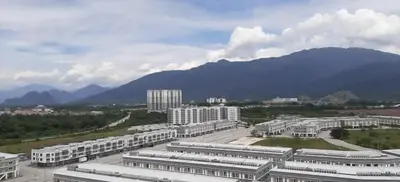 a city with buildings and mountains in the background at Cozy Suite - Near UTAR - Champs Elysees Kampar in Kampar