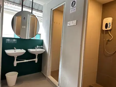 a bathroom with two sinks and a mirror at Georgetown landed Guest House WL in George Town