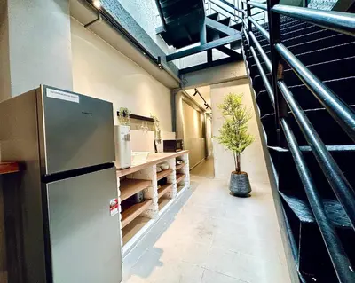 a kitchen with a refrigerator and a counter in a room at Georgetown landed Guest House WL in George Town