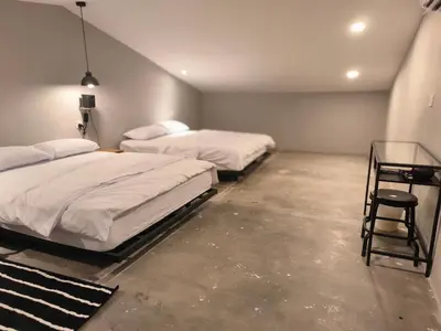 a room with two beds and a glass table at Georgetown landed Guest House WL in George Town