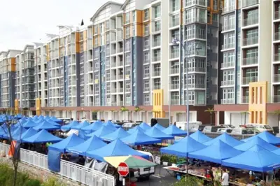 a large building with blue umbrellas in front of it at G Residence - 2BR Family Suite Barrington Night Market - 4 in Brinchang