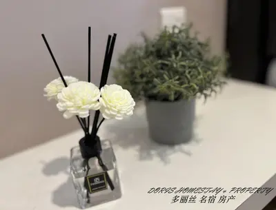 two flowers in a glass vase on a table at 10pax -2 Storey House Bayu Mutiara at Bukit Mertajam in Bukit Mertajam