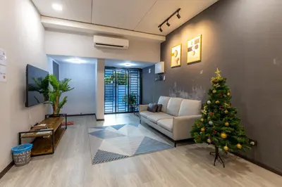 a christmas tree in a living room with a couch at -NEW- 22Pax 5R4B V KTV,KID'S POOL,POOL TABLE NEAR USM,LWE HOSPITAL,SPI ARENA in George Town