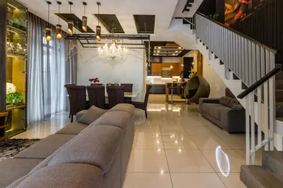 a living room with a couch and a dining room at Varnen Cozy Haven - EVCharger in Bukit Mertajam