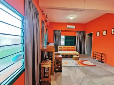 a living room with orange walls and a table at Ipoh town centre - safari 5 pax(2BR) in Ipoh