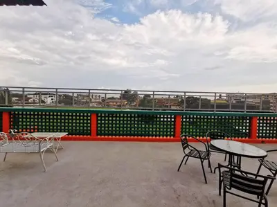 a patio with tables and chairs on a balcony at Ipoh town centre - safari 5 pax(2BR) in Ipoh