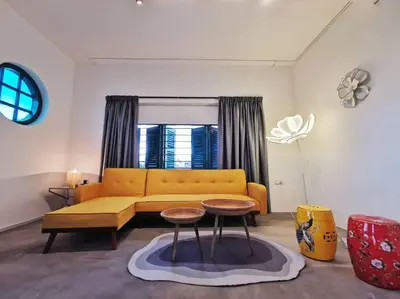 a living room with a yellow couch and a table at Ipoh town centre eastern oriental 8 pax(2BR) in Ipoh