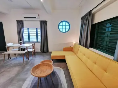 a living room with a yellow couch and a table at Ipoh town centre eastern oriental 8 pax(2BR) in Ipoh
